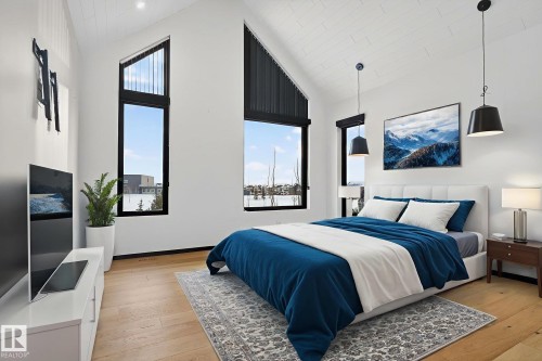 Bedroom featuring light wood-style floors and high vaulted ceiling - 104 Edgewater Circle, Leduc, AB - Indoor Photo Showing Bedroom