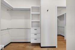 Spacious closet with light wood-style flooring - 