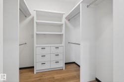 Walk in closet with light wood finished floors - 