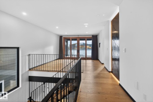 Corridor with french doors, light wood-type flooring, recessed lighting, and an upstairs landing - 104 Edgewater Circle, Leduc, AB - Indoor Photo Showing Other Room