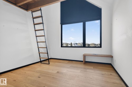 Spare room featuring light wood-style flooring and beamed ceiling - 104 Edgewater Circle, Leduc, AB - Indoor Photo Showing Other Room