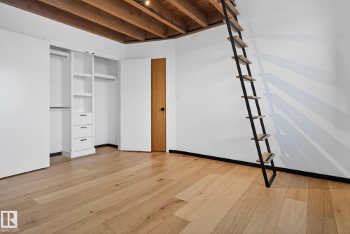 Unfurnished bedroom featuring light wood-style floors, a closet, and beam ceiling - 104 Edgewater Circle, Leduc, AB - Indoor Photo Showing Other Room