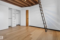 Unfurnished bedroom featuring light wood-style floors, a closet, and beam ceiling - 