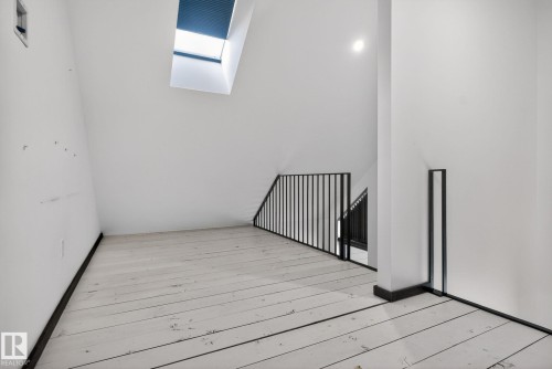 Unfurnished room with a skylight and hardwood / wood-style floors - 104 Edgewater Circle, Leduc, AB - Indoor Photo Showing Other Room