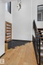 Foyer entrance with hardwood / wood-style floors, a towering ceiling, and stairs - 104 Edgewater Circle, Leduc, AB  - Indoor Photo Showing Other Room 