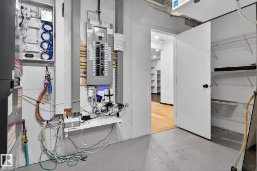 Utility room with electric panel and heating unit - 104 Edgewater Circle, Leduc, AB - Indoor Photo Showing Other Room