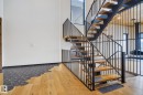 Stairway featuring wood-type flooring and a high ceiling - 104 Edgewater Circle, Leduc, AB  - Indoor Photo Showing Other Room 