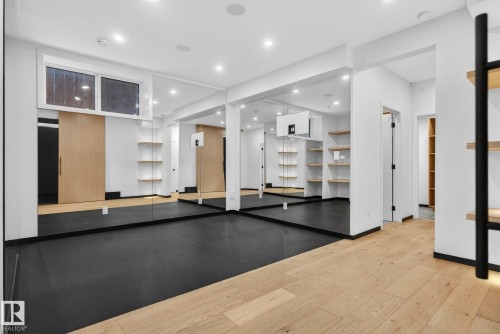 Workout room featuring light wood-style floors and recessed lighting - 104 Edgewater Circle, Leduc, AB - Indoor Photo Showing Other Room