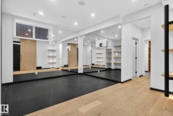 Workout room featuring light wood-style floors and recessed lighting - 