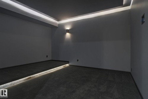 Carpeted cinema featuring baseboards - 104 Edgewater Circle, Leduc, AB - Indoor Photo Showing Other Room