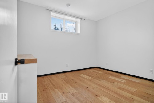 Spare room with light wood-style floors and baseboards - 104 Edgewater Circle, Leduc, AB - Indoor Photo Showing Other Room
