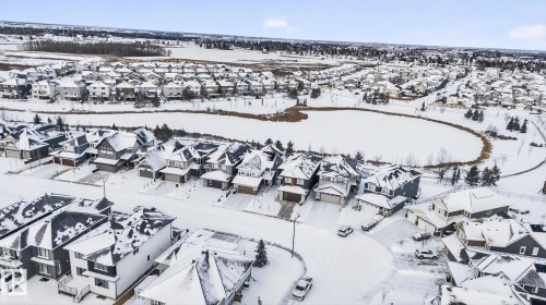 Snowy aerial view featuring a residential view - 104 Edgewater Circle, Leduc, AB - Outdoor With View