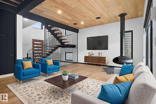 Living area with stairway, wood ceiling, light wood-style floors, and recessed lighting - 104 Edgewater Circle, Leduc, AB - Indoor Photo Showing Living Room