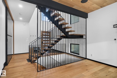Stairs with wood-type flooring and plenty of natural light - 104 Edgewater Circle, Leduc, AB - Indoor Photo Showing Other Room