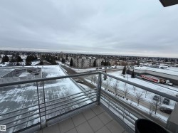 View of snow covered back of property - 