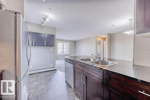 202 5816 Mullen Place, Edmonton, AB - Indoor Photo Showing Kitchen With Double Sink