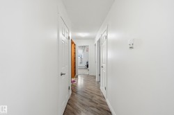 Hall featuring baseboards and light wood finished floors - 