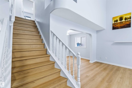 Stairway with arched walkways and wood finished floors - 115 Deer Ridge Drive, St. Albert, AB - Indoor Photo Showing Other Room