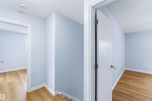 Corridor with a textured ceiling and light wood-style flooring - 115 Deer Ridge Drive, St. Albert, AB - Indoor Photo Showing Other Room