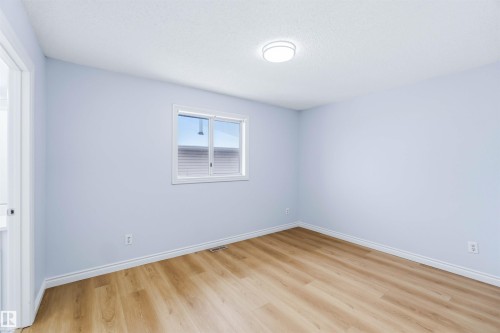 Spare room featuring light wood-style floors and a textured ceiling - 115 Deer Ridge Drive, St. Albert, AB - Indoor Photo Showing Other Room