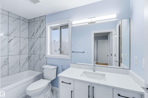 Bathroom featuring vanity, bathtub / shower combination, and marble finish floors - 115 Deer Ridge Drive, St. Albert, AB - Indoor Photo Showing Bathroom