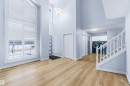Foyer entrance with healthy amount of natural light, a chandelier, a high ceiling, and light wood-style floors - 115 Deer Ridge Drive, St. Albert, AB  - Indoor Photo Showing Other Room 