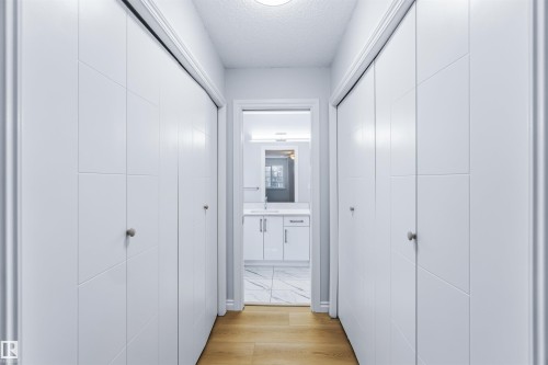 Hallway featuring light wood-type flooring and a textured ceiling - 115 Deer Ridge Drive, St. Albert, AB - Indoor Photo Showing Other Room