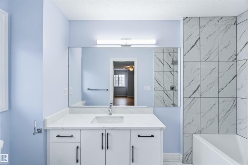 Full bath with vanity, a textured ceiling, shower / bathtub combination, a ceiling fan, and light marble finish flooring - 115 Deer Ridge Drive, St. Albert, AB - Indoor Photo Showing Bathroom