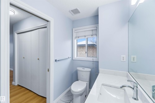 Bathroom featuring light marble finish flooring, vanity, and a textured ceiling - 115 Deer Ridge Drive, St. Albert, AB - Indoor Photo Showing Bathroom