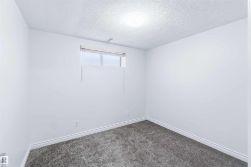 Empty room with a textured ceiling and carpet floors - 115 Deer Ridge Drive, St. Albert, AB - Indoor Photo Showing Other Room