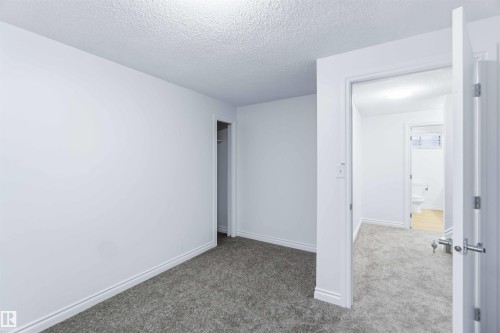Spare room featuring a textured ceiling and carpet floors - 115 Deer Ridge Drive, St. Albert, AB - Indoor Photo Showing Other Room
