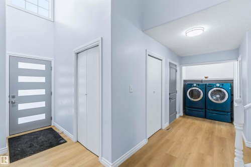 Laundry area with light wood finished floors and washer and dryer - 115 Deer Ridge Drive, St. Albert, AB - Indoor Photo Showing Laundry Room