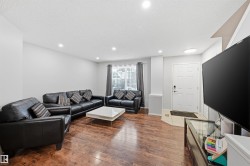 Living area featuring a textured ceiling, dark wood-type flooring, and recessed lighting - 