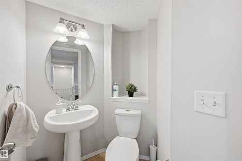 Half bath with a textured ceiling and toilet - 21017 60 Avenue, Edmonton, AB - Indoor Photo Showing Bathroom