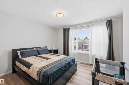 Bedroom featuring a textured ceiling and wood finished floors - 21017 60 Avenue, Edmonton, AB - Indoor Photo Showing Bedroom