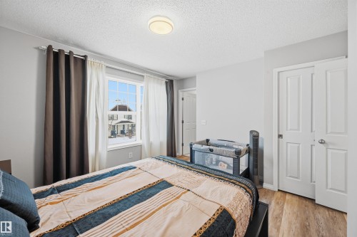 Bedroom featuring a textured ceiling and light wood-type flooring - 21017 60 Avenue, Edmonton, AB - Indoor Photo Showing Bedroom