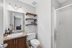 Bathroom with a stall shower, vanity, and a textured ceiling - 