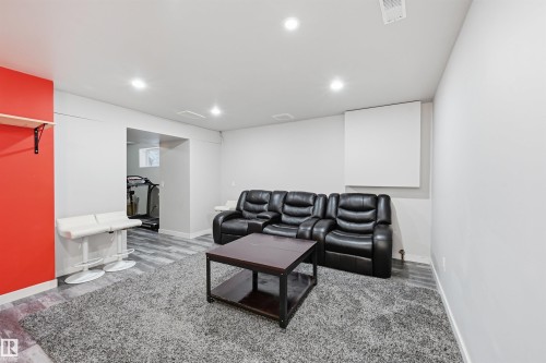 Recreation room with recessed lighting and wood finished floors in the basement - 21017 60 Avenue, Edmonton, AB - Indoor