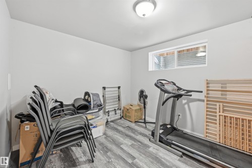 Bedroom are with wood finished floors and baseboards - 21017 60 Avenue, Edmonton, AB - Indoor Photo Showing Gym Room