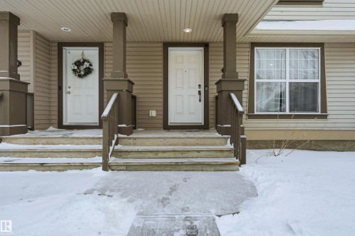 Snow covered property entrance featuring a porch - 21017 60 Avenue, Edmonton, AB - Outdoor With Deck Patio Veranda