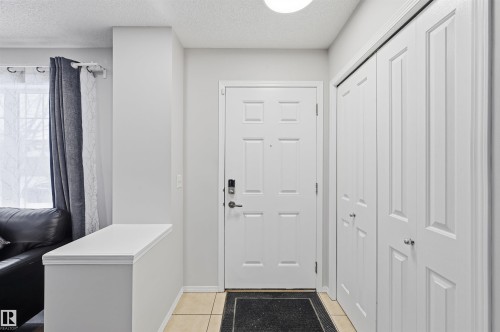 Doorway featuring a textured ceiling and tile patterned flooring - 21017 60 Avenue, Edmonton, AB - Indoor Photo Showing Other Room