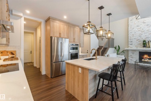 53 Deer Meadow Crescent, Fort Saskatchewan, AB - Indoor Photo Showing Kitchen With Fireplace With Upgraded Kitchen