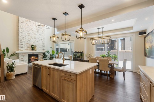 53 Deer Meadow Crescent, Fort Saskatchewan, AB - Indoor Photo Showing Kitchen With Fireplace With Upgraded Kitchen
