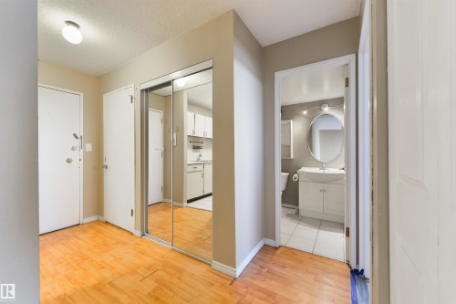 Hall featuring light wood-type flooring and a textured ceiling - 601 13910 Stony Plain Road, Edmonton, AB - Indoor Photo Showing Other Room