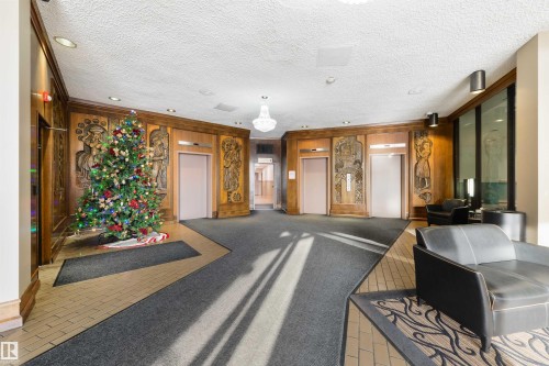 Community lobby featuring wooden walls and a textured ceiling - 601 13910 Stony Plain Road, Edmonton, AB - Indoor Photo Showing Other Room
