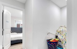 Hallway featuring light colored carpet - 