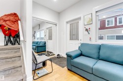 Living area with light wood-style flooring and baseboards - 