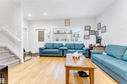 Living room featuring stairs, light wood-style flooring, and recessed lighting - 