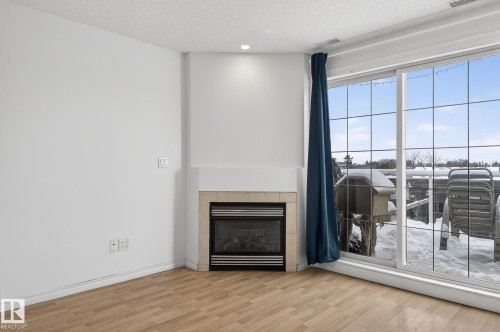 420 12110 106 Avenue, Edmonton, AB - Indoor Photo Showing Other Room With Fireplace