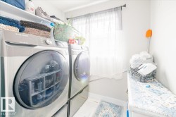 Laundry room featuring washer and dryer and baseboards - 